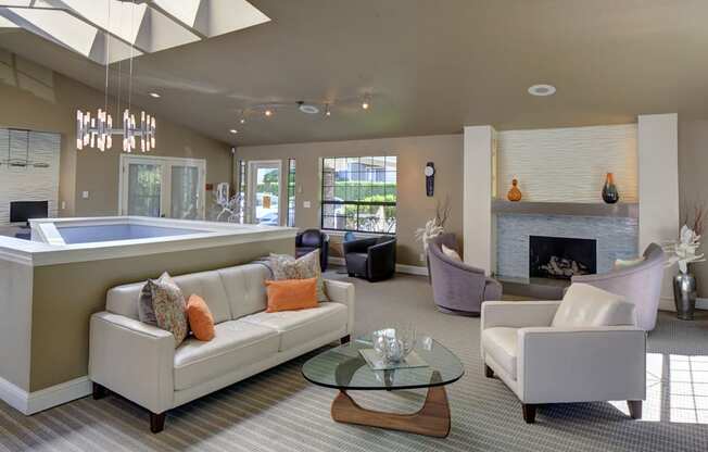 Resident clubhouse with a fireplace surrounded by lounge seating at 2000 Lake Washington Apartments, Renton, WA