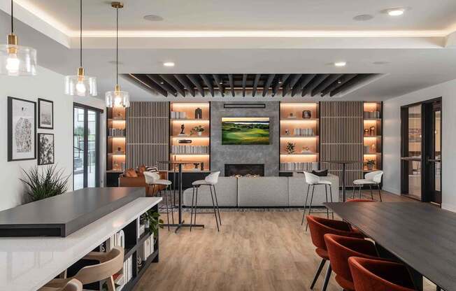 A modern dining room with a long table and chairs.