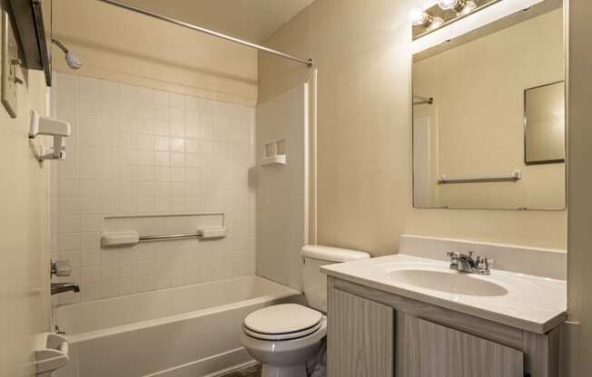 a bathroom with a sink toilet and a bath tub