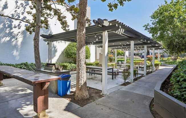 A park with a bench and a tree under a canopy.