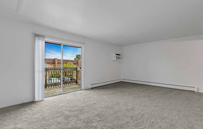 a bedroom with a sliding glass door and a balcony