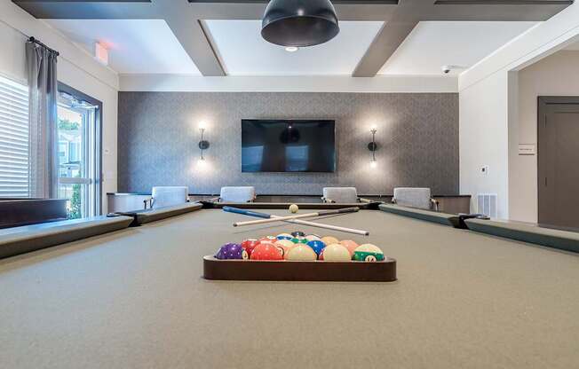 a game room with a pool table and a television