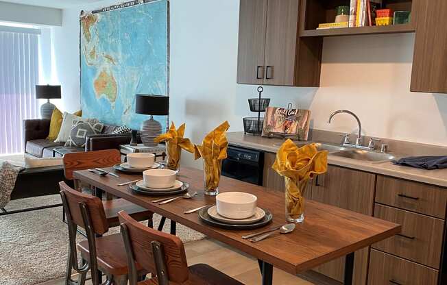 a kitchen and dining room with a wooden table and chairs