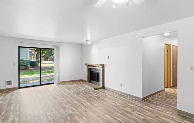A room with a fireplace and sliding glass doors.