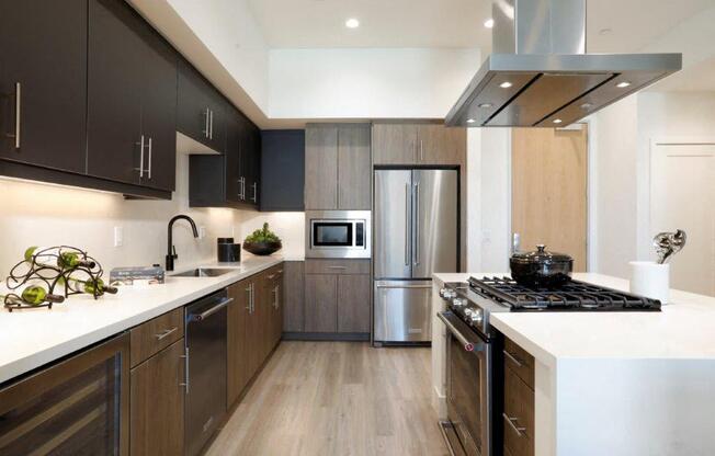 a modern kitchen with stainless steel appliances and wooden cabinets
