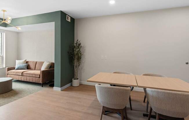 A room with a couch, chairs, and a table.