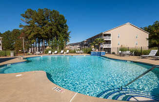 A large swimming pool with a blue tiled edge and a white line in the middle.