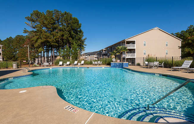 A large swimming pool with a blue tiled edge and a white line in the middle.