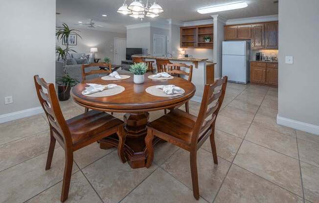 A dining room with a table set for four.
