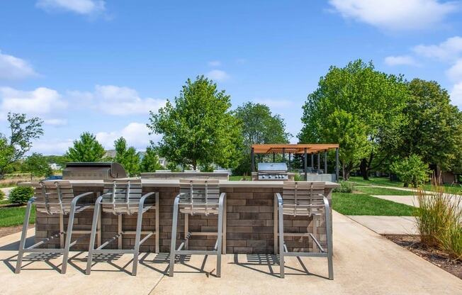 a patio with a bar and grill in a park