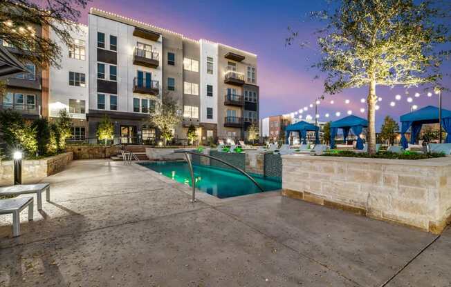 A building with a pool in front of it.