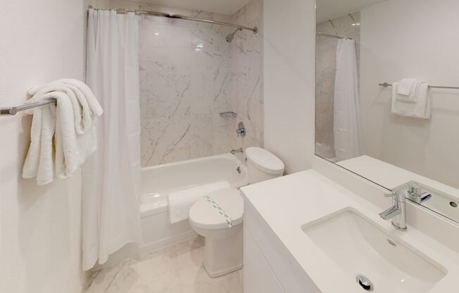 a bathroom with a sink toilet and bathtub