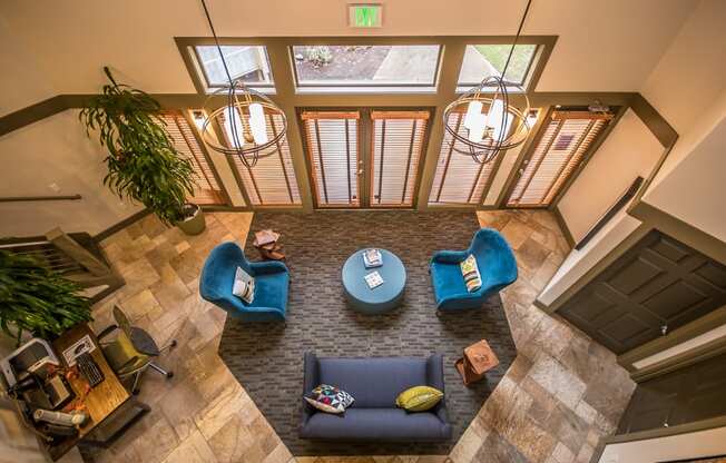 an overhead view of a living room with blue couches and chairs