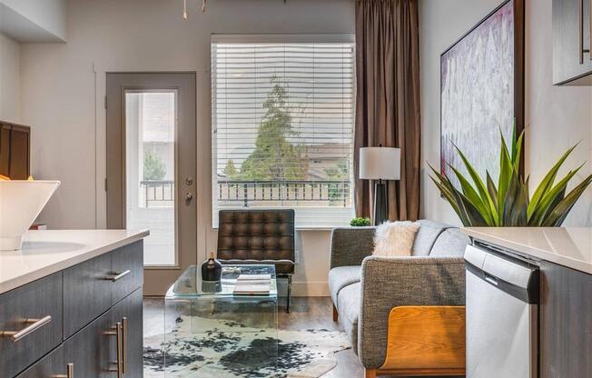 a living room with a couch and a glass table  at Affinity 56 Apartments in West Jordan, Utah