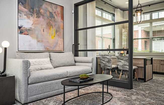 A grey couch with a coffee table in front of it.