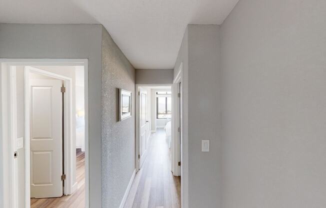 a hallway with grey walls and white trim