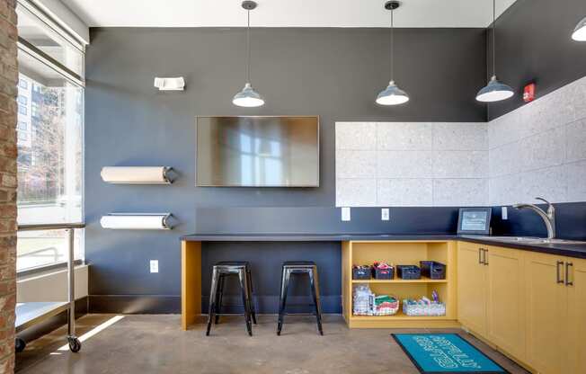 a kitchenette with a bar and stools