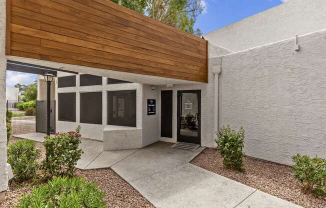 a white building with a wooden awning over the front door