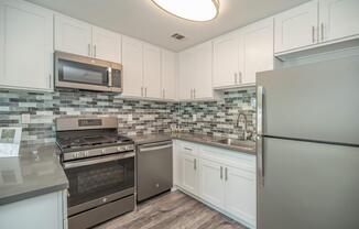 a kitchen with a stove and a refrigerator
