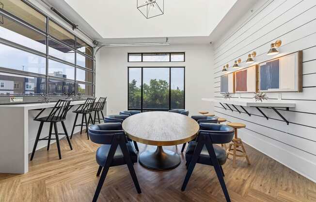 a dining room with a table and chairs