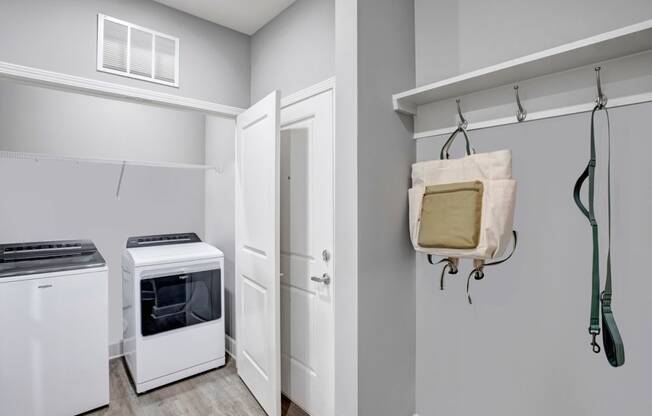 a laundry room with a stove and a door to a closet