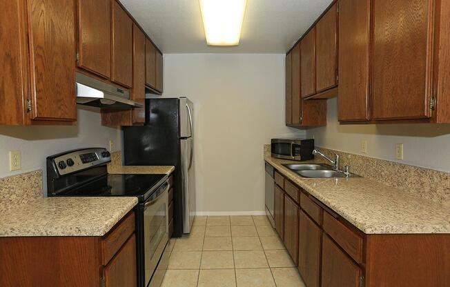 a kitchen with stainless steel appliances and wooden cabinets