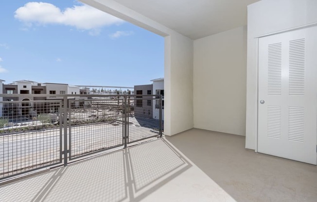 A white room with a view of a construction site through a window.