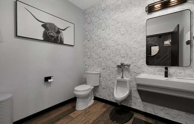 a bathroom with a picture of a bull on the wall