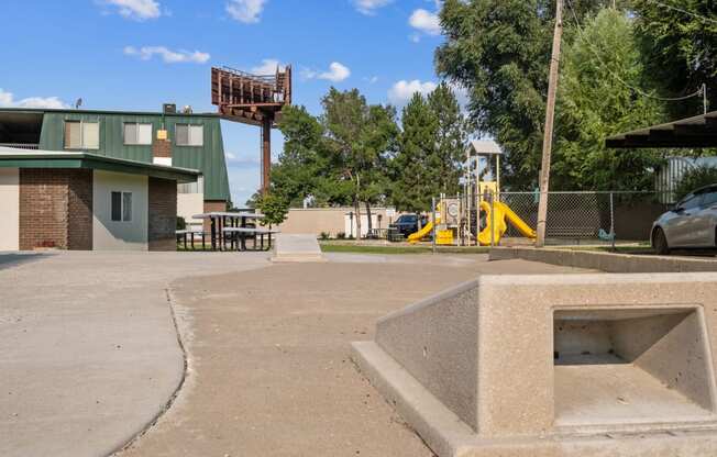 a park with a playground and a building in the background