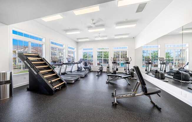 A gym with treadmills, exercise bikes, and other equipment.