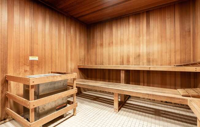 an empty sauna with wooden walls and benches