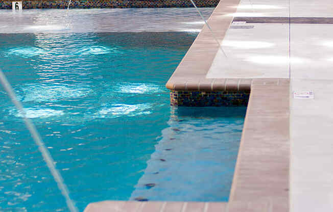 two white fountains in a swimming pool