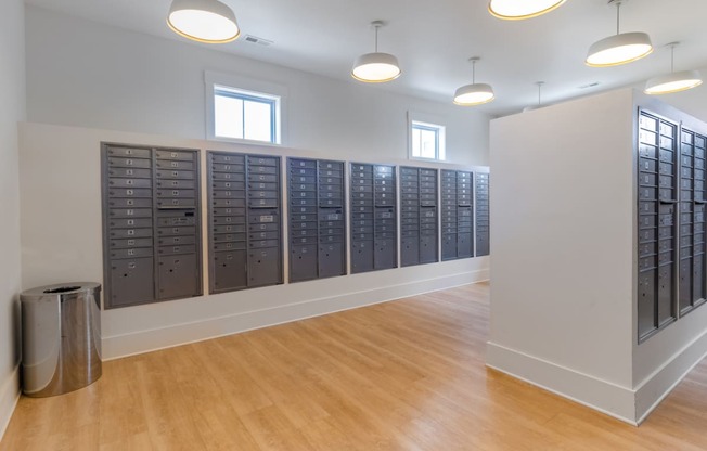 a large room with lockers and a trash can