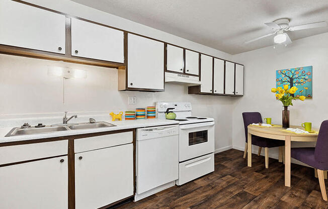 a kitchen with white cabinets and a dining room table