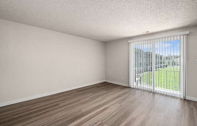 an empty room with a sliding glass door