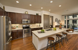 a kitchen with a large island and stainless steel appliances