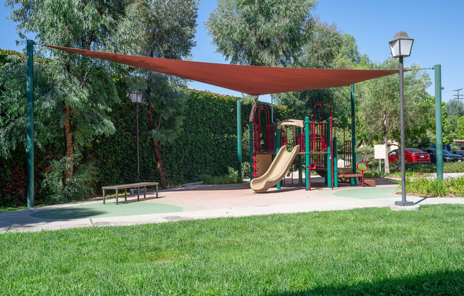 a playground with a swing set and a jungle gym