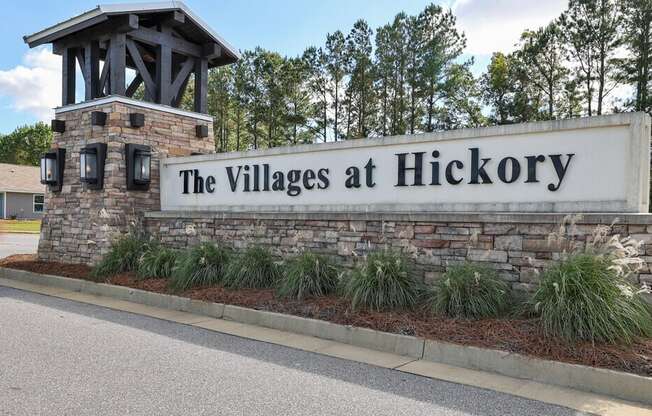 the villages at hickory sign at the entrance of the village