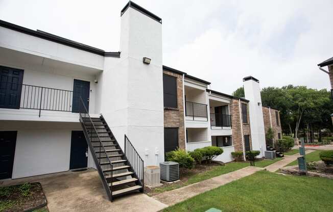 an exterior view of a building with stairs and a courtyard