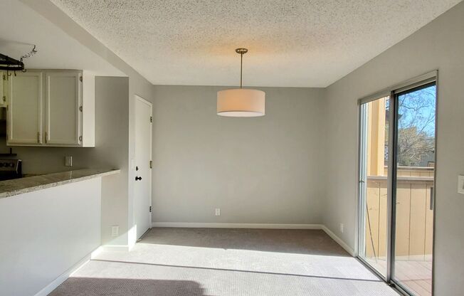 Upstairs Condo with 2 Car Garage, Fresh Paint, Wood Floors, Large Patio, Pool!
