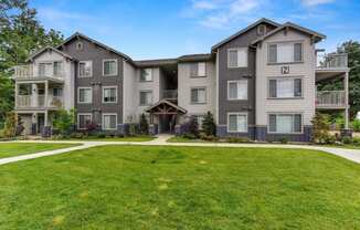 Front of Avaya Trails with Grass, Walking Path, Gray Apartment Exteriors