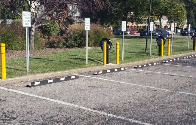 a parking lot with yellow and black dividers on the ground