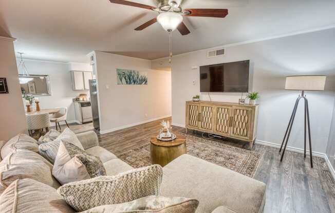 a living room with a couch and a ceiling fan