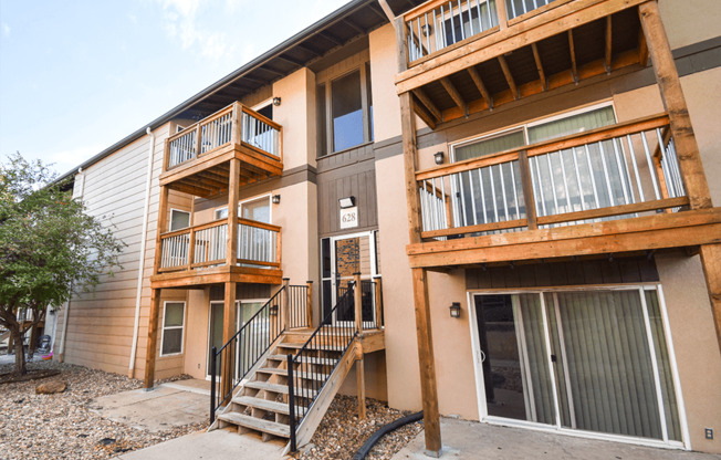 an exterior view of an apartment building with stairs and balconies