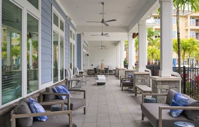 a porch with couches and chairs on a patio