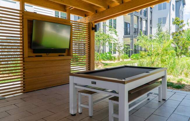 A table tennis table is set up on a patio.