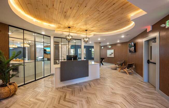 A reception area with a wooden ceiling and a glass wall.