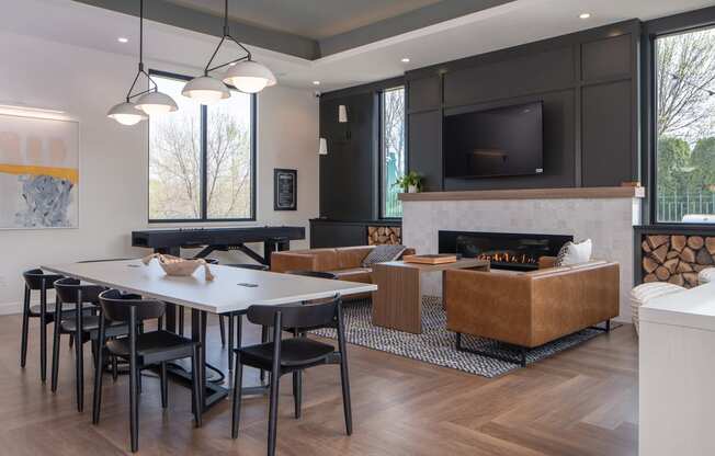 a living room with a table and chairs and a fireplace