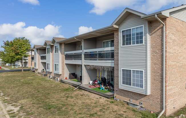 an apartment building with a yard in front of it