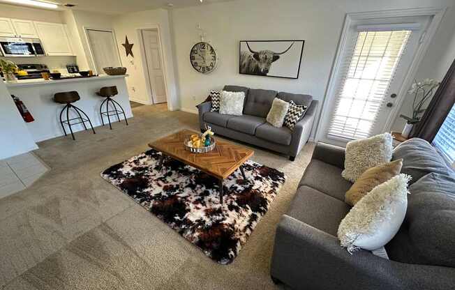A living room with a grey couch and a coffee table.
